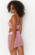 Side view of a pink sparkle mini skirt with a textured, slightly sheer finish
