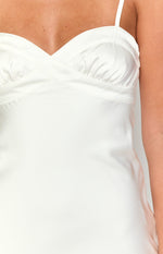 Close-up of the white satin mini dress bodice with sweetheart neckline, criss-cross detail, and ruched cups