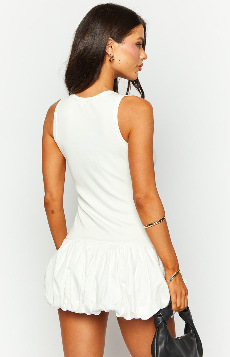 Rear-side view of a white sleeveless ribbed tank mini dress with a voluminous gathered bubble hem skirt