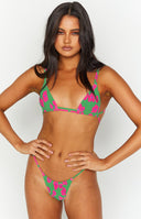 Close-up of a green floral triangle bikini top with pink flowers and thin straps