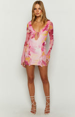 Pink floral mesh mini dress with a deep V-neck, tie-front detail, ruffled trim, and long flared sleeves