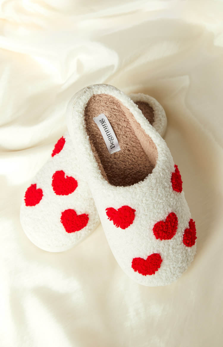 Beginning Boutique Sweetheart Sole White Love Heart Slippers white fluffy slippers with red heart pattern and brown faux fur lining