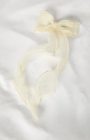 girl wearing a cream hair bow with pearl details