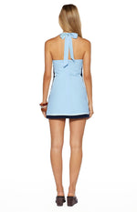 Rear view of the light blue micro mini dress with a halter neck tie, open back, dark blue side panels, and a two-tone hem