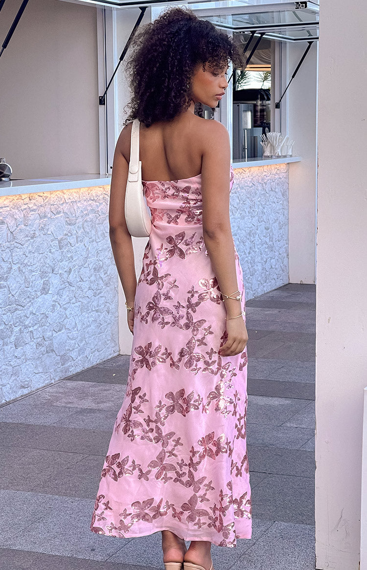 Rear-side view of a pink strapless maxi dress with all-over rose gold butterfly sequins