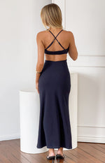 Rear view of a navy crepe maxi dress with criss-cross adjustable spaghetti straps and a cut-out back