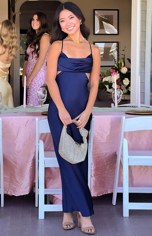 Fitted navy formal maxi dress featuring a draped cowl neck and prominent side waist cutouts
