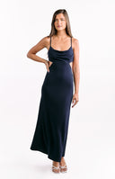 Girl in a long navy evening gown made from crepe fabric with a high neckline and a backless design.