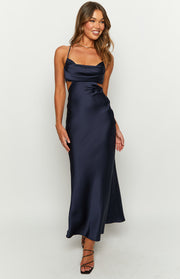 Navy satin maxi dress with a cowl neckline, thin spaghetti straps, and side cutouts