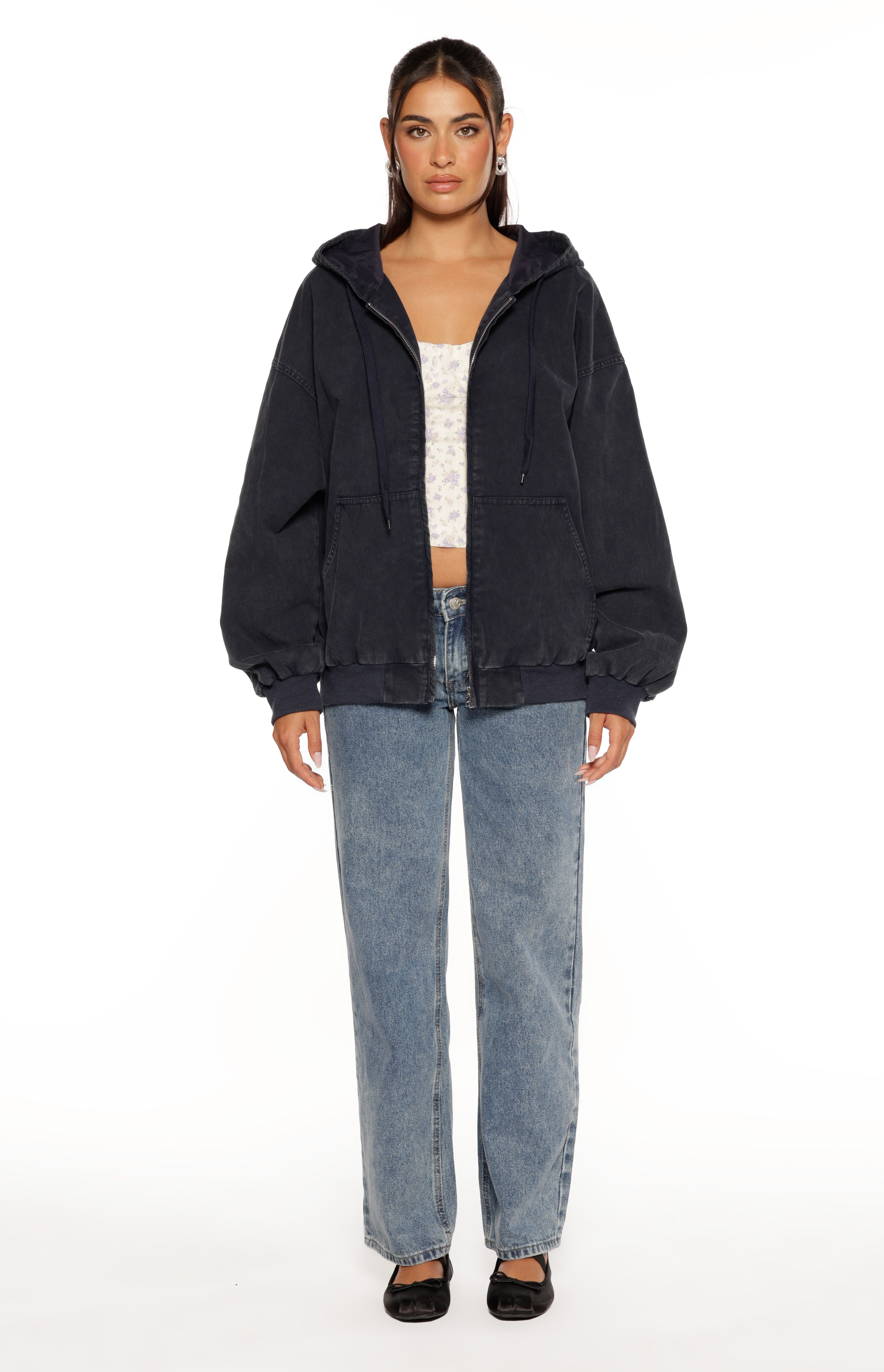 Front view of a washed navy oversized hooded jacket, partially unzipped, showing the hood lining and front patch pockets