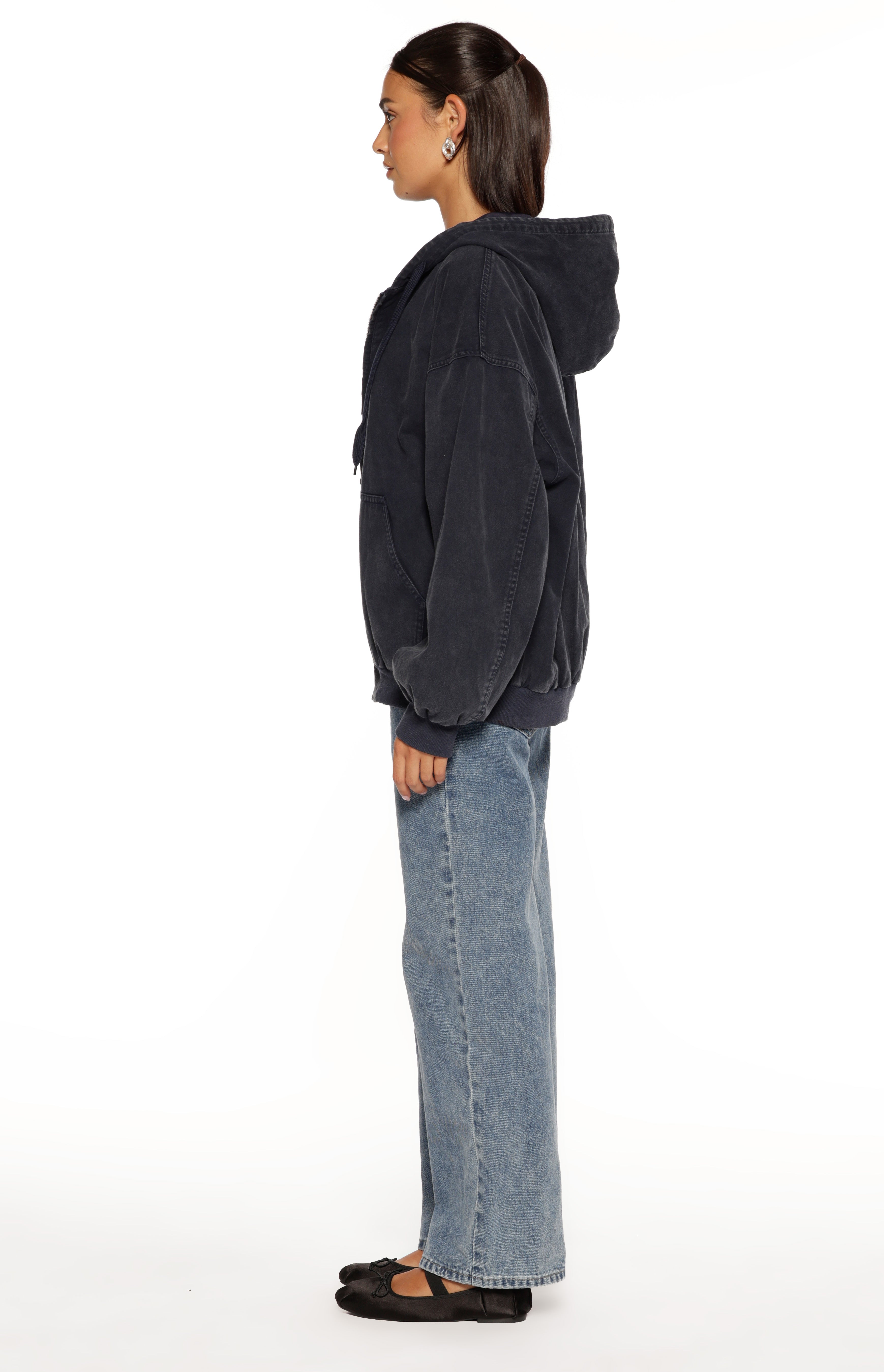 Side view of a washed navy oversized hooded jacket with ribbed cuffs and hem