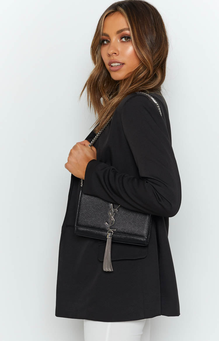 Black long sleeve blazer with a smooth fabric and a relaxed, open front