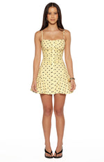 Front view of a yellow polka dot mini dress with a ruched button-front bodice and flared skirt