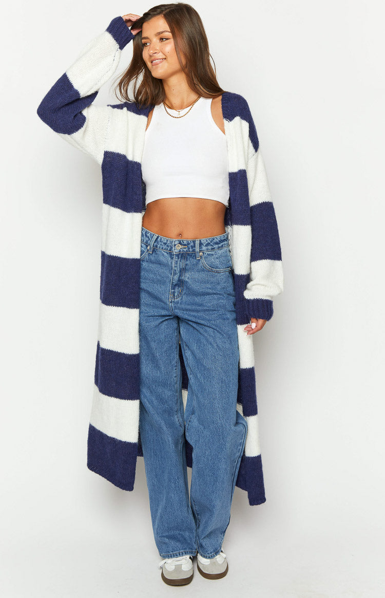 Front view of a longline blue and white striped knit cardigan with an oversized fit and wide stripes