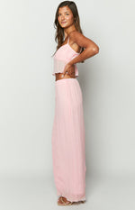 Side view of a light pink crinkled maxi skirt with a relaxed, full-length silhouette