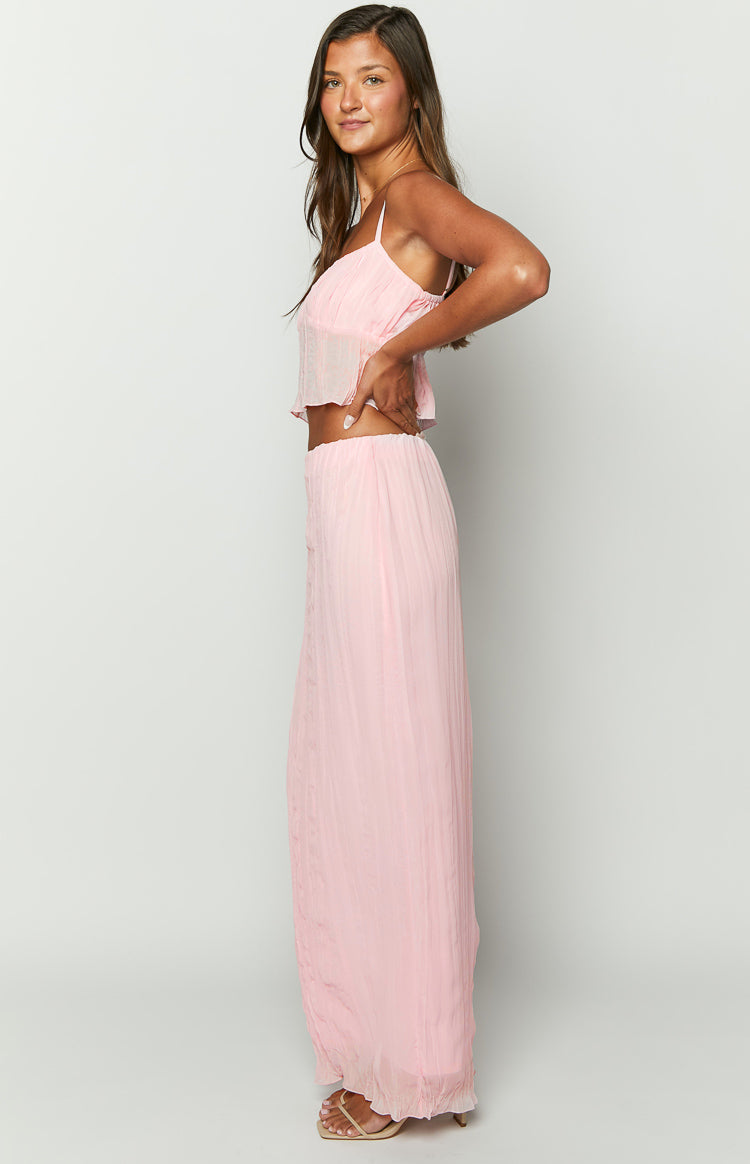 Side view of a light pink crinkled maxi skirt with a relaxed, full-length silhouette