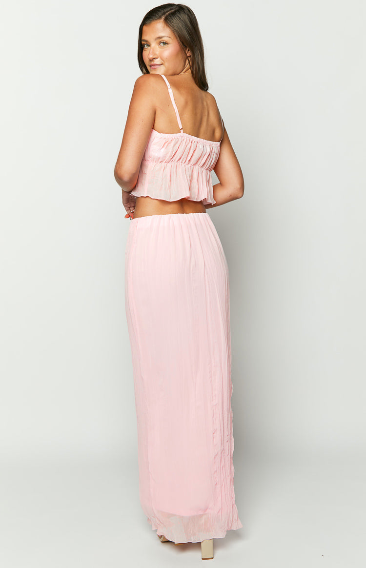 Close-up of the elasticated waistband and crinkled texture of the pink maxi skirt