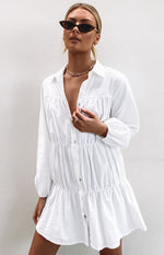 White collared dress with a button-front, gathered bodice, and tiered skirt in a textured fabric