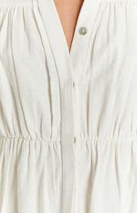 White textured dress with V-neck, button placket, and elasticated gathered waist