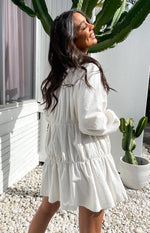 White textured tiered dress with long billowy sleeves and a gathered drawstring waist