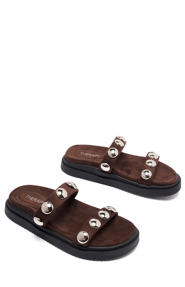 Top-down view of chocolate brown suede platform sandals with two wide straps adorned with silver studs