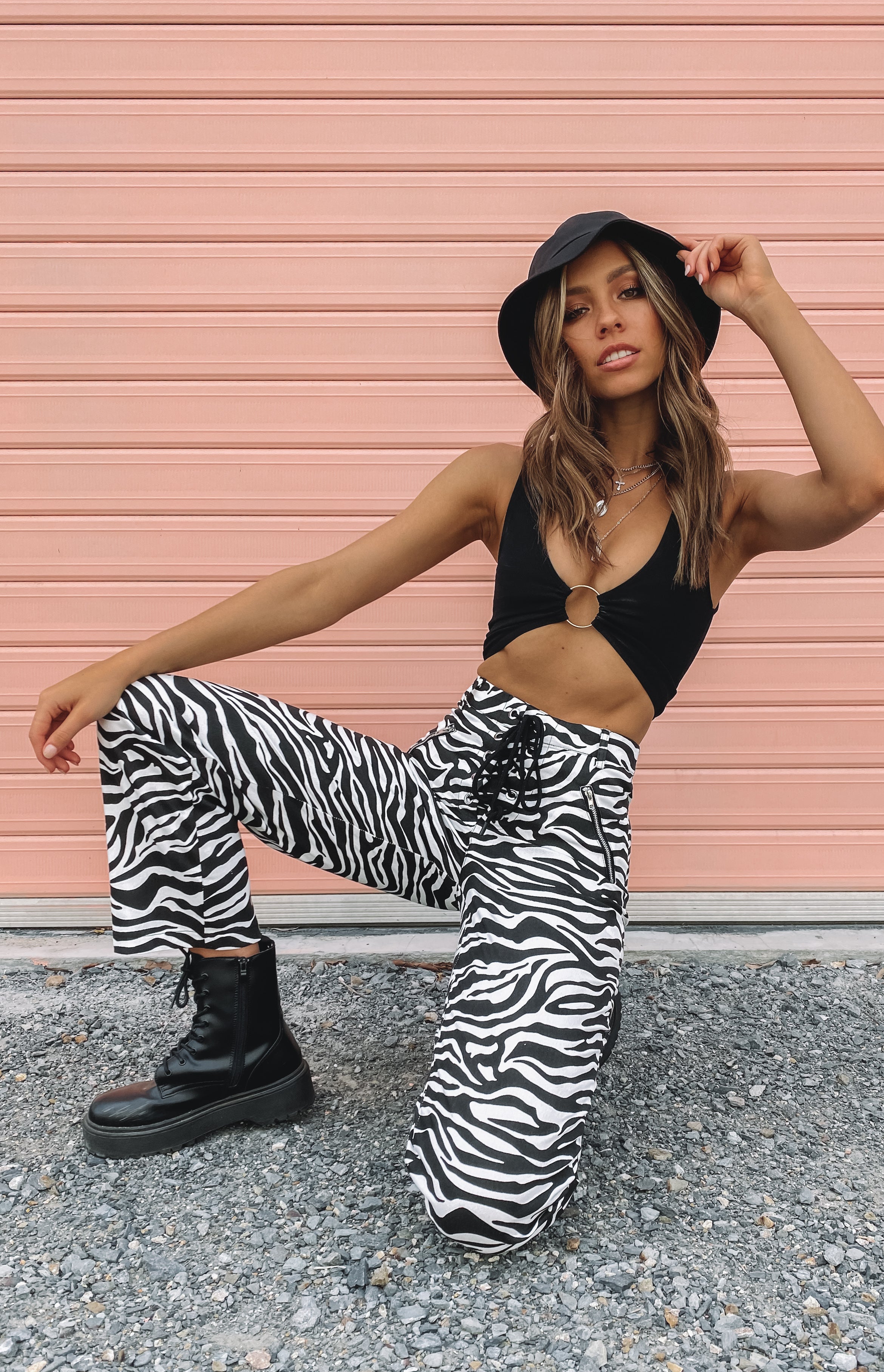 Black and white zebra print wide leg pants with a lace-up front and practical side zipper pockets