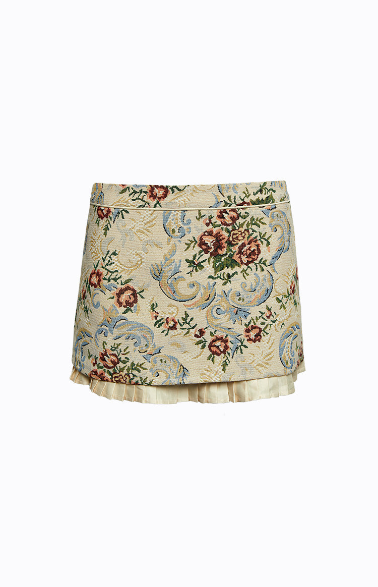 Front view of a beige tapestry mini skirt with floral pattern and pleated cream hem trim