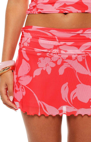 Model in the Tilley Red Floral Ruched Mini Skirt styled with the matching top a perfect co-ord for a party or day event.