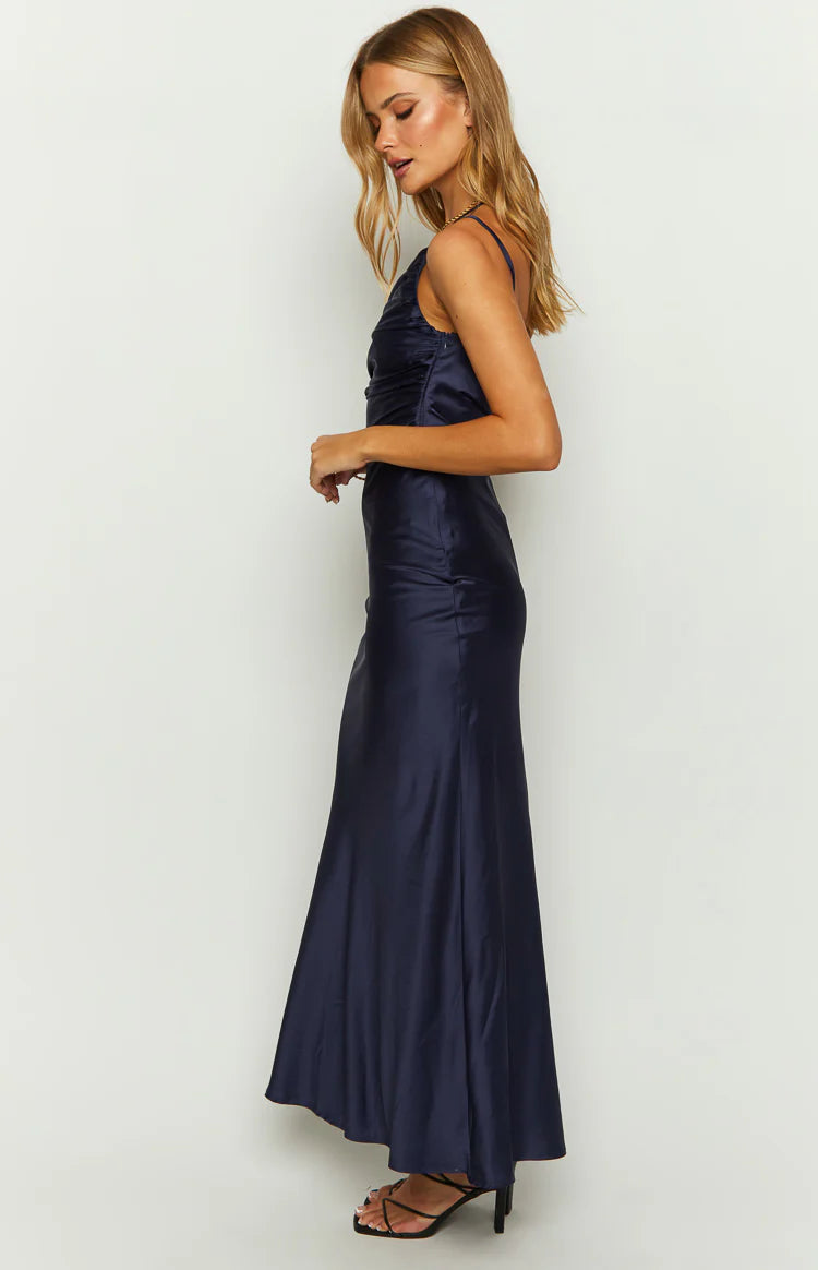 Side view of a navy satin maxi dress showing the ruched bodice and flowing skirt