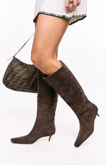 Side view of espresso suede calf boots with a pointed toe, kitten heel, and inner side zipper