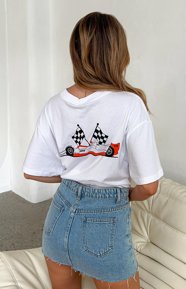 Back view of a white oversized tee with a red and white race car graphic and two black and white checkered flags