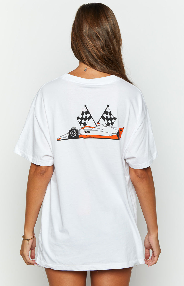 Rear view of a white oversized tee with a graphic of an orange and white race car and two checkered flags