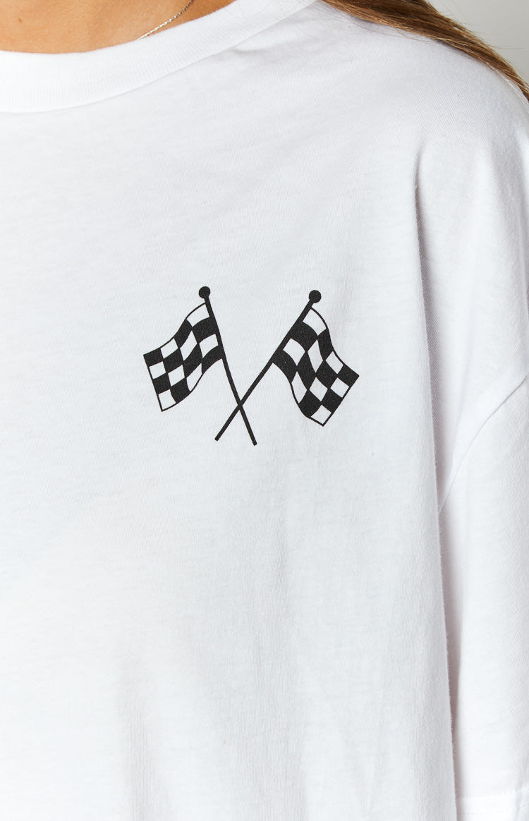 White tee with a graphic print of two crossed black and white checkered flags
