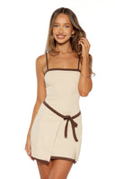 Beginning Boutique Tora Cream Wrap Tie Mini Dress cream mini dress with brown contrast trim, square neckline, spaghetti straps, and wrap tie waist