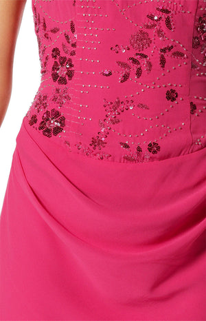 Close-up of the hot pink mini dress showing intricate floral beading and sequins on the bodice, with a draped skirt