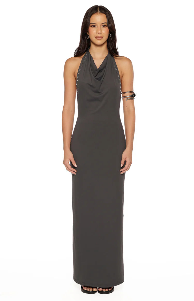 Front view of a grey bodycon maxi dress with a cowl neck and silver stud details along the halter straps