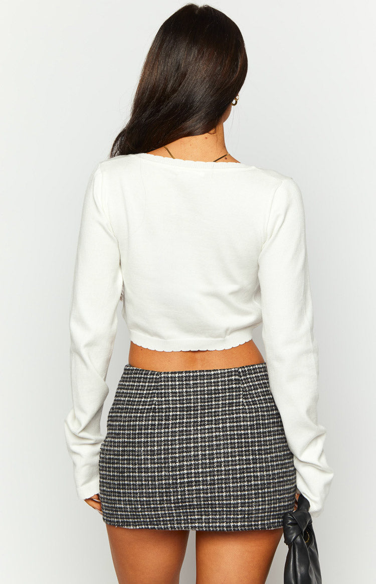 Side view of a grey plaid mini skirt, showing the short length and fitted silhouette