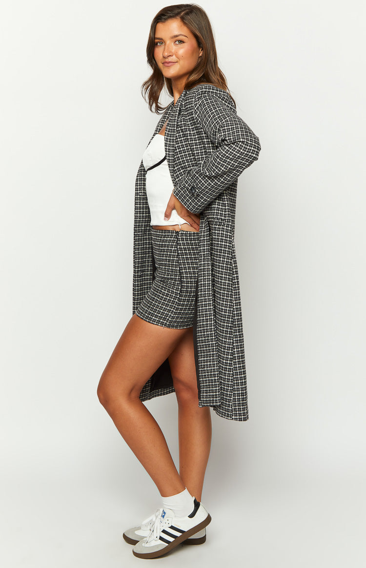 Side view of the grey and white plaid pattern on a fitted mini skirt