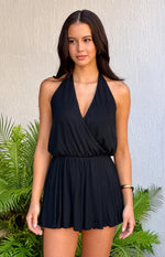 Black halter neck playsuit with a deep V-neck wrap bodice, elasticated waist and flowy shorts