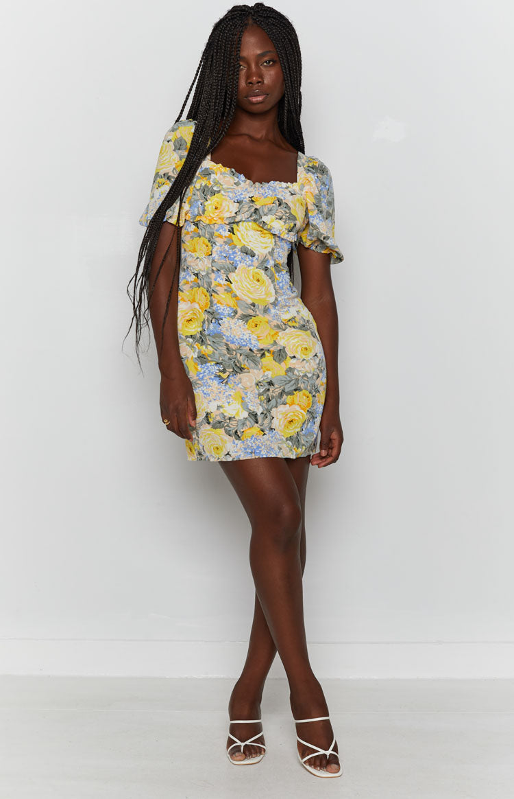 Yellow and blue floral mini dress with a backless design, tie-up neck, and puffed short sleeves