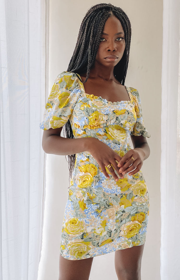 Yellow and blue floral mini dress with an open back and tie closure, short puff sleeves