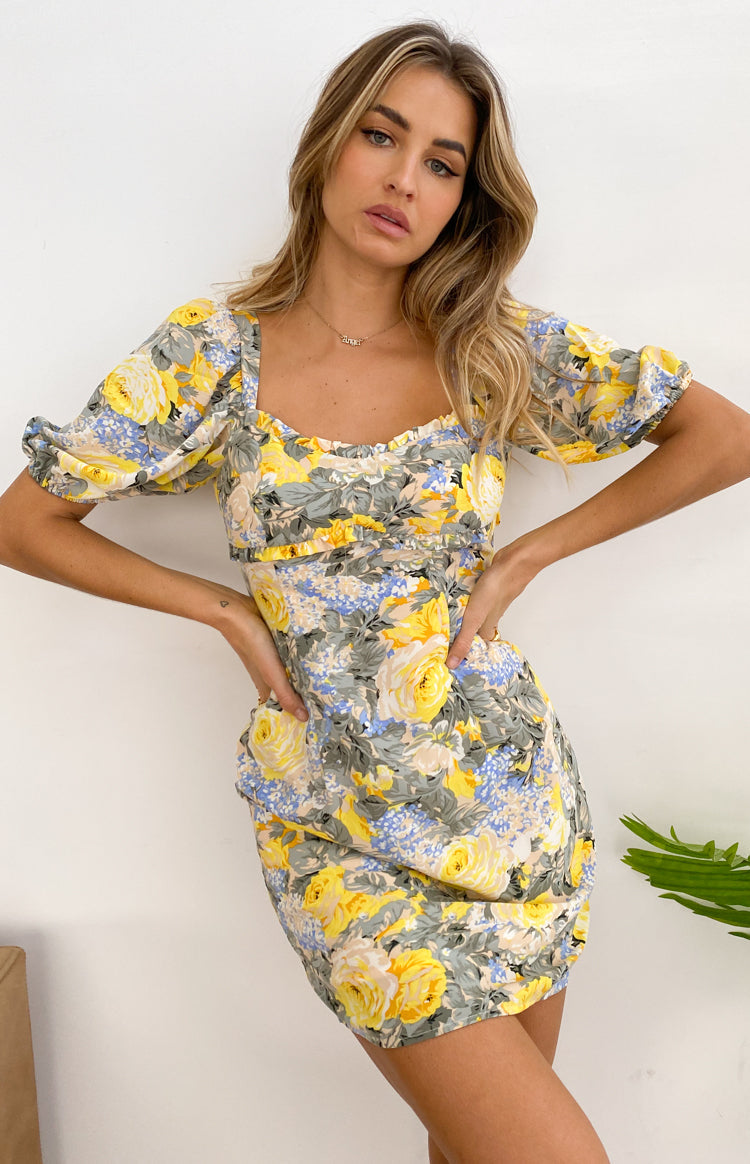 Mini dress with large yellow and blue floral print, ruffled square neckline, and short puff sleeves