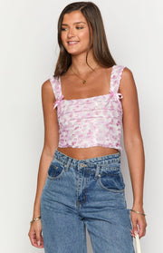 Pink floral lace crop top with a square neckline, wide straps, pink bows, and horizontal pleated front
