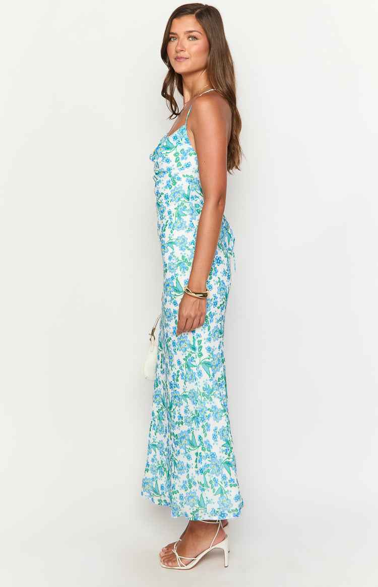 Side view of a blue floral maxi dress with a cowl neckline and side lacing detail