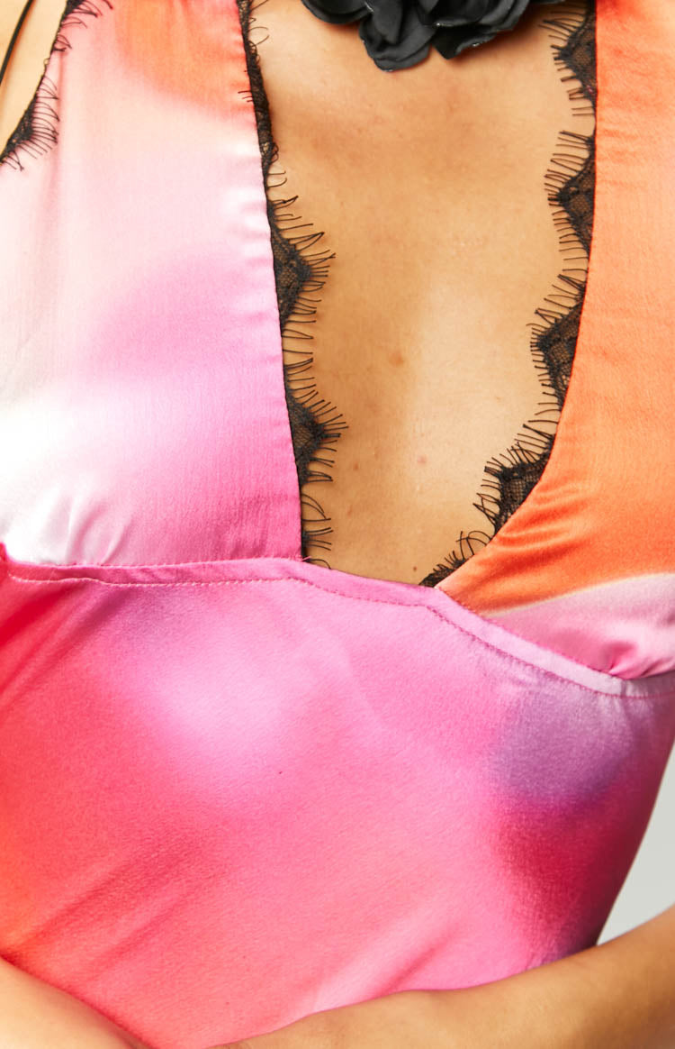 Top-down view of the pink print halter neck maxi dress with deep V-neckline and black lace trim
