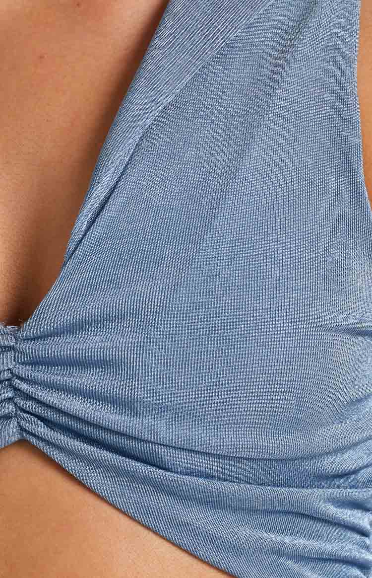 Blue ribbed knit dress fabric with fine vertical texture and ruched detail