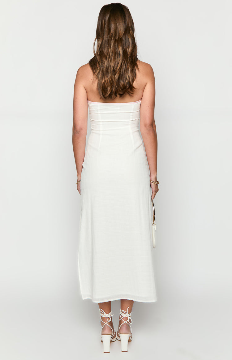 Rear view of a white strapless maxi dress with a fitted bodice, horizontal seams, and a pink-lined top edge