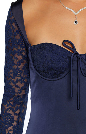 Close-up of the navy lace long sleeve and sweetheart neckline with tie-front detail