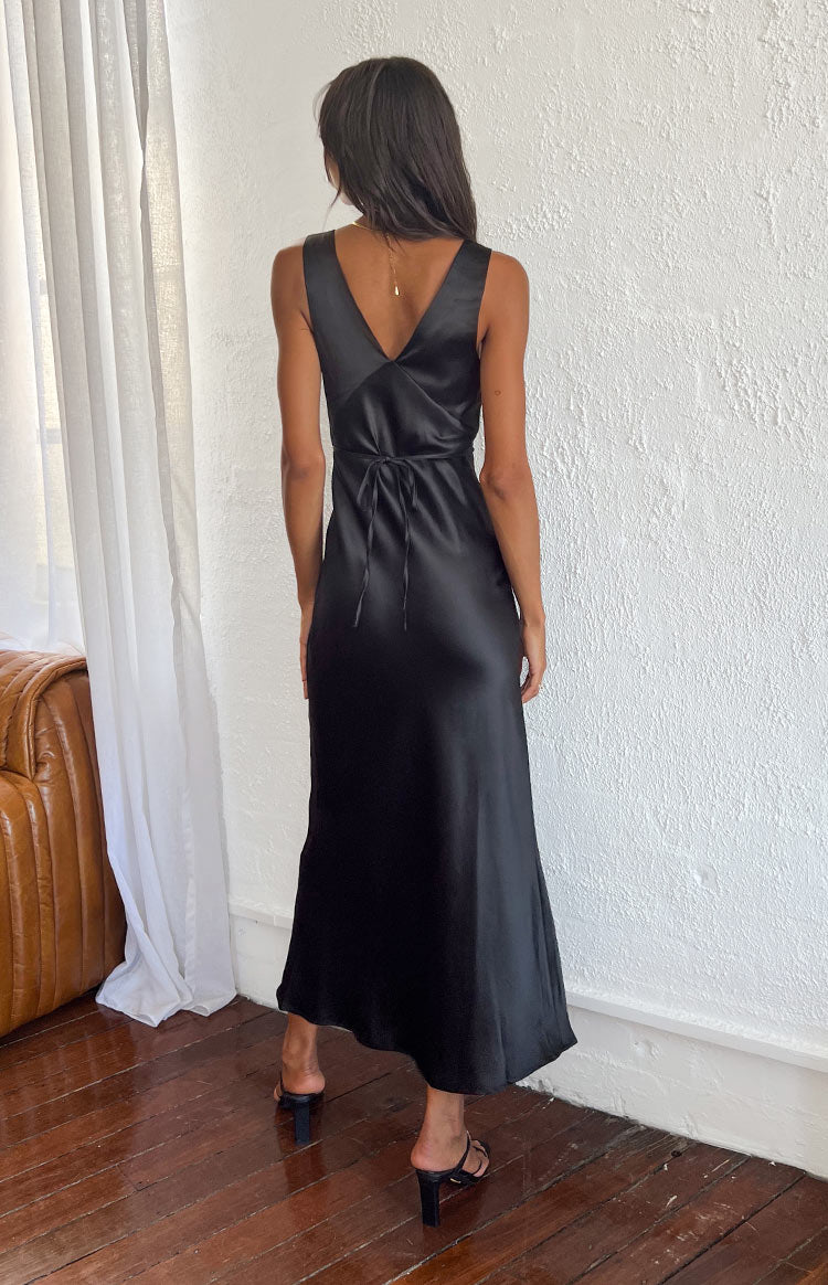 Rear view of a black satin maxi dress showing the V-neck back and tie-waist detail