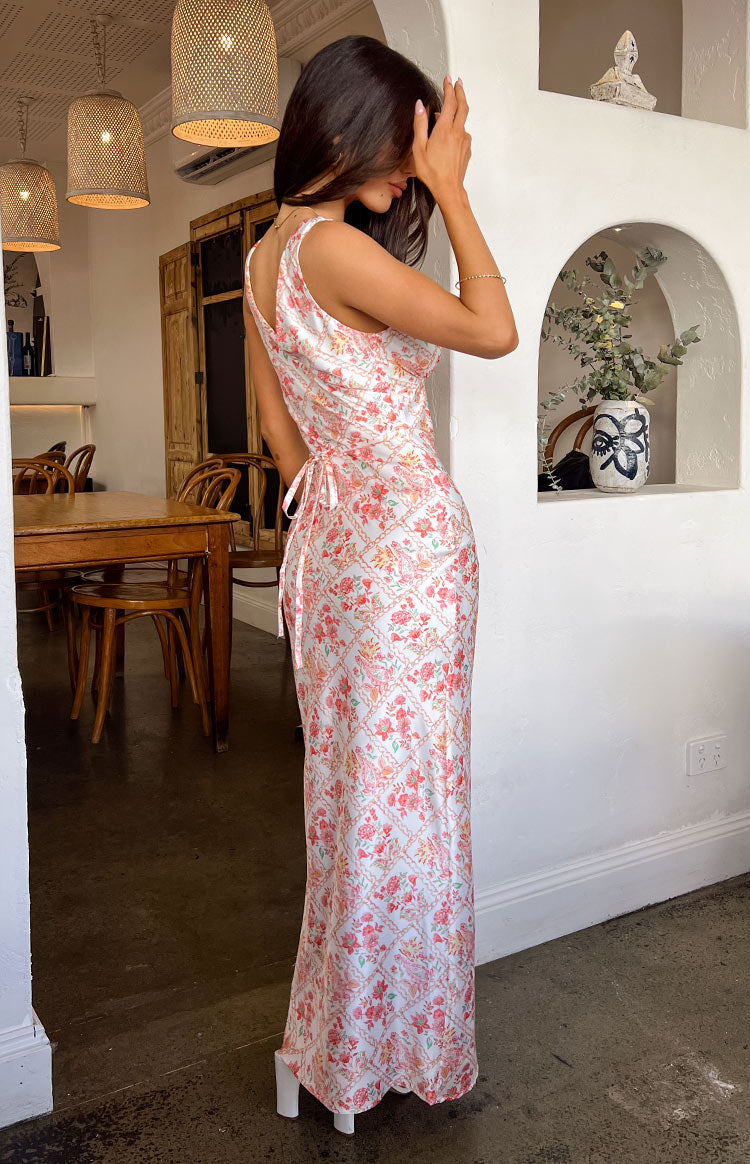 Side view of the white floral paisley maxi dress with a low V-neck back and adjustable side tie detail